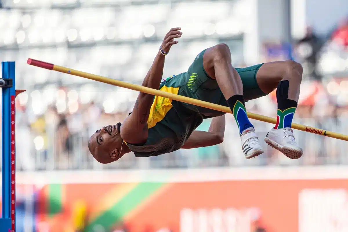 Atleta in gara di salto in alto durante una competizione internazionale