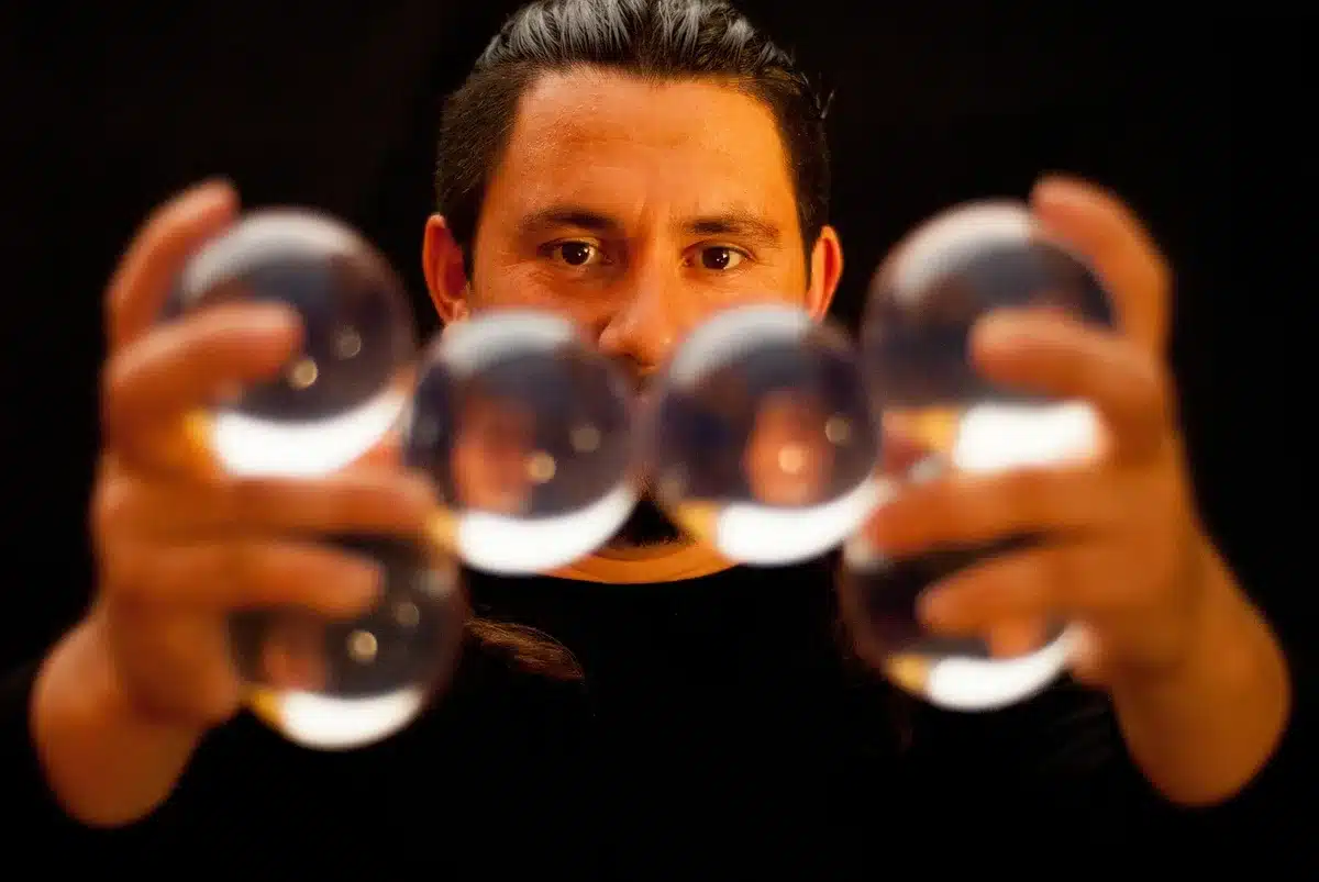 Mani anonime che inseriscono palline numerate in un tamburo della lotteria in movimento